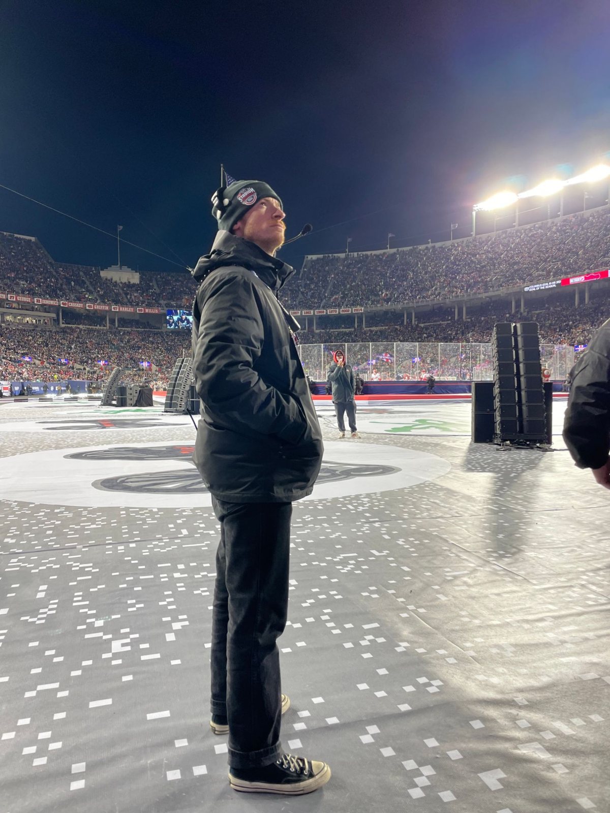 Austin on the field during an NHL Stadium Series game, wearing a headset