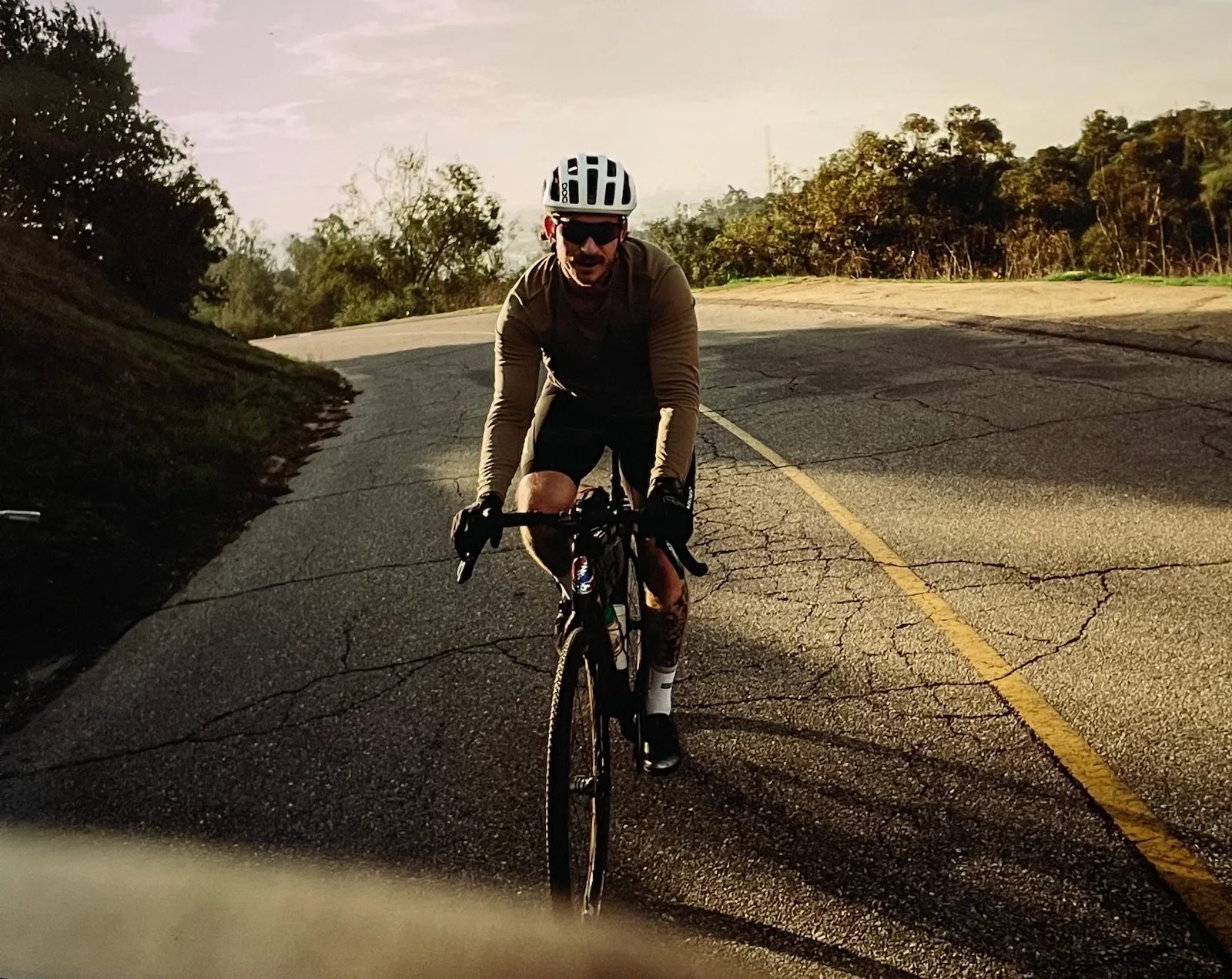 Austin riding a road bike up a hill